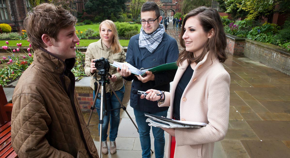 Students interviewing a man in the Old Quadrangle